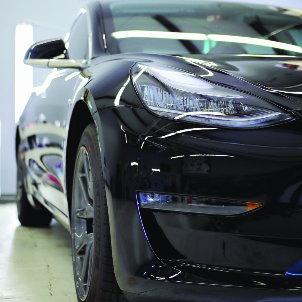 Black tesla with paint protection film applied