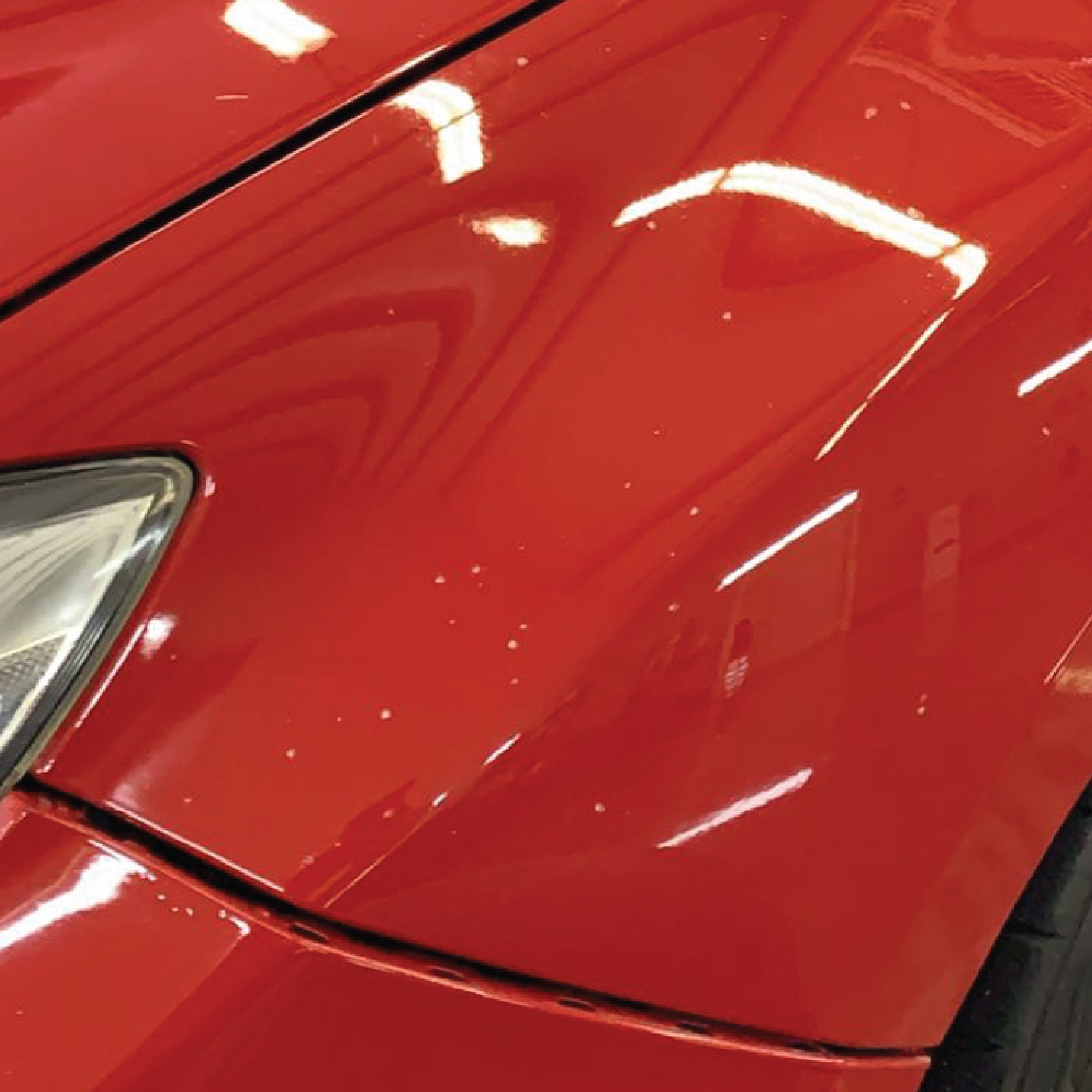 Red vehicle with rock chips